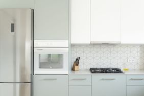 clean bright kitchen with light blue and white cabinets