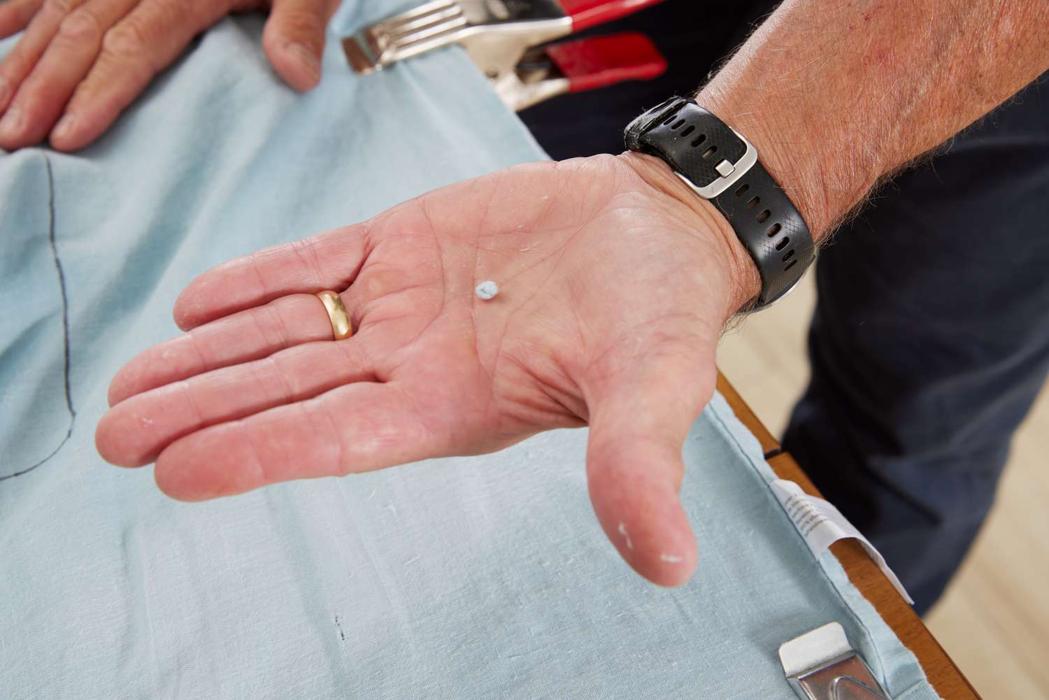 Person holds pilling from Tuft & Needle Hemp Sheet Set