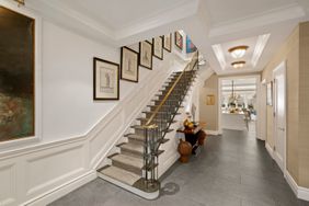 wainscoting along a stairwell with artwork on walls