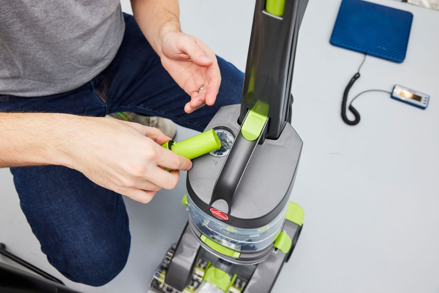 Close up of person removing the top to a Hoover Pro Clean Pet Carpet Cleaner FH51050