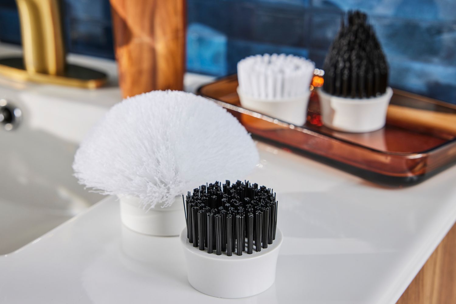 Attachments for a Klever Electric Spin Scrubber with 8 Brushes sitting on a bathroom sink