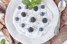 High-Calcium Foods: Greek yogurt with blackberries, blueberries and chia seeds on a white wooden rustic table