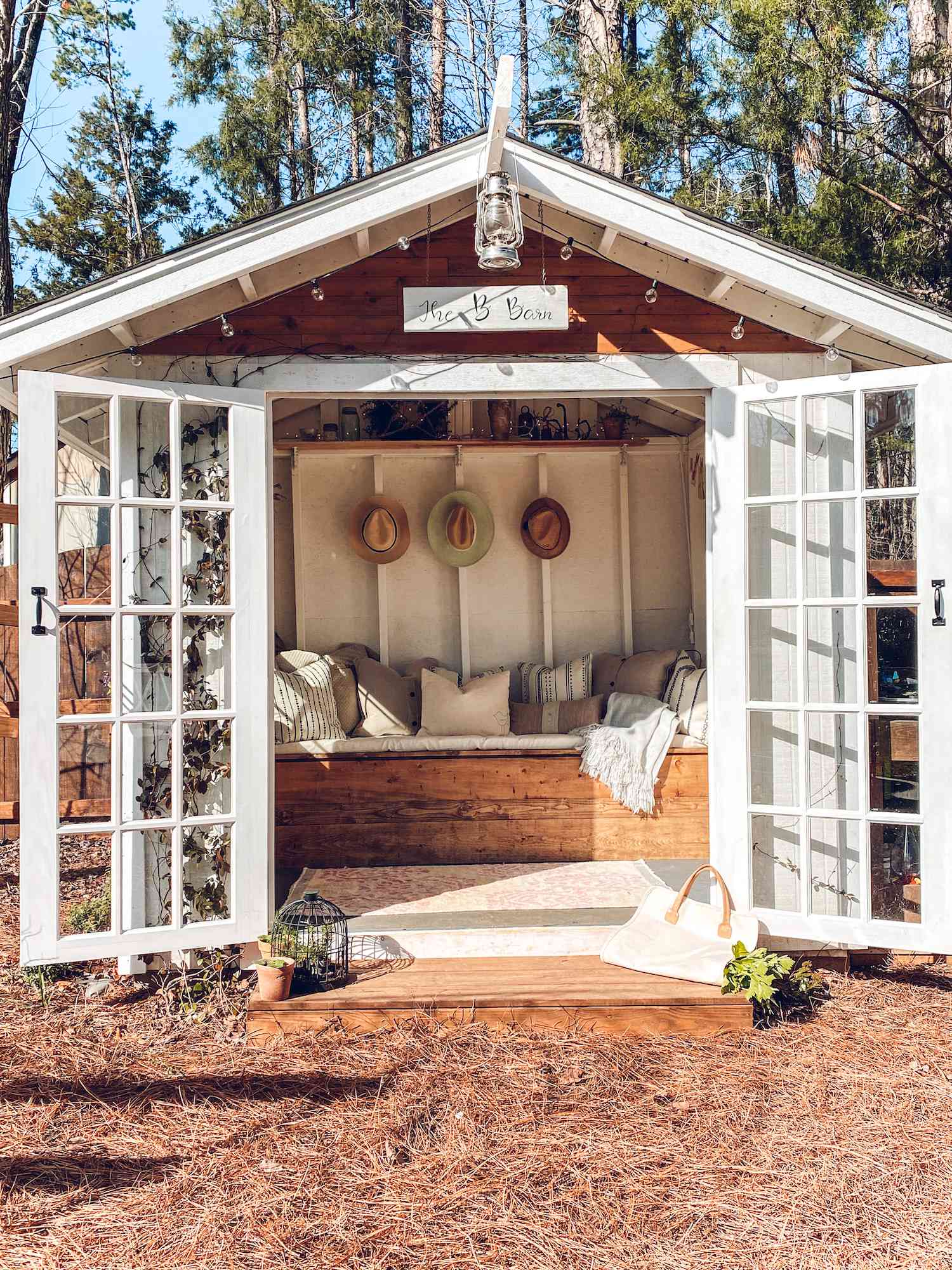 Outdoor shed with bench and cozy cushions, glass French doors