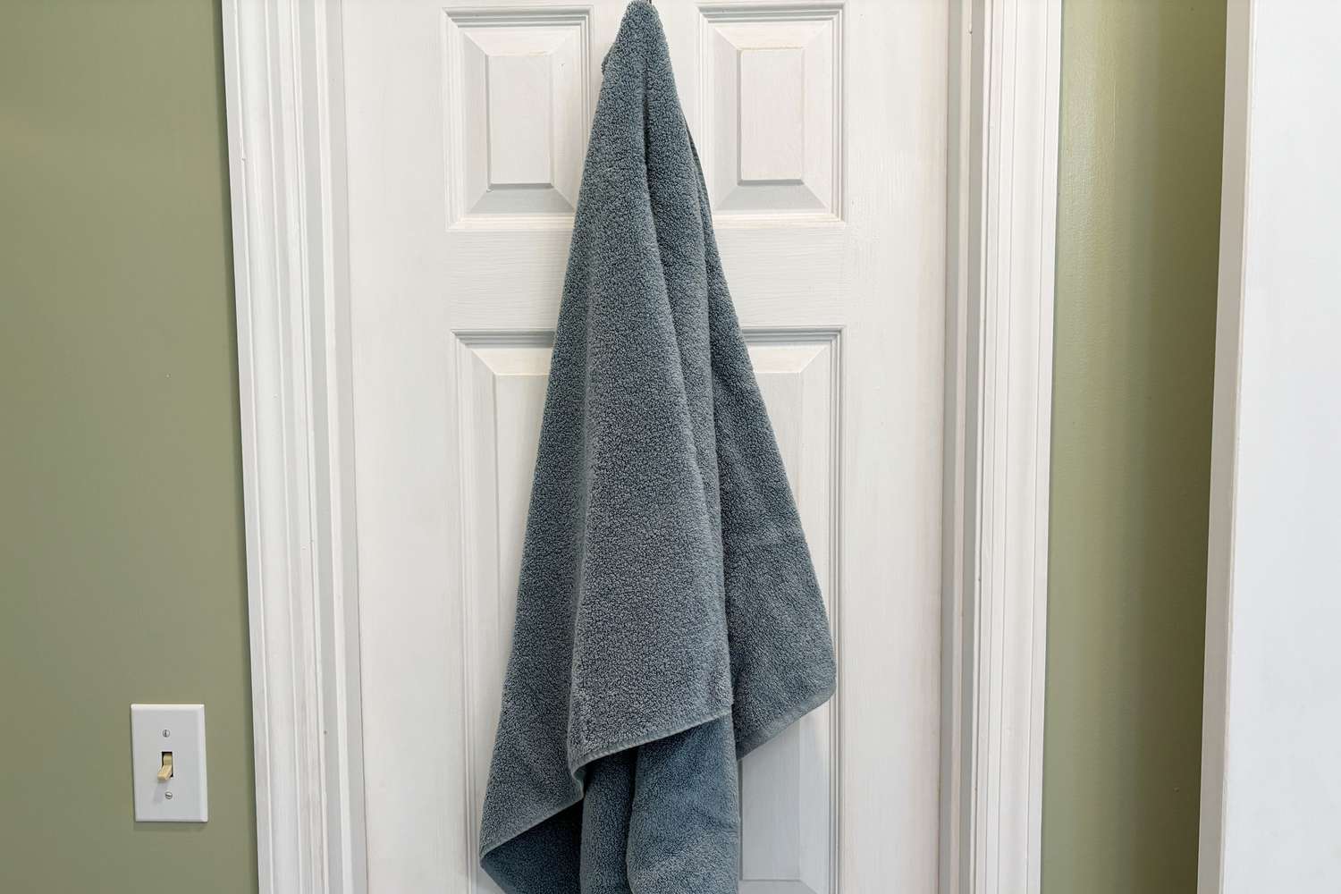 A Bamboo Bliss Resort Bamboo Collection by RHH Bath Towels hangs on a door hook