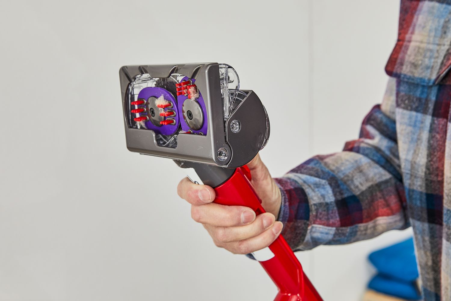 A hand holding Dyson Ball Animal 3 Extra nozzle at an angle