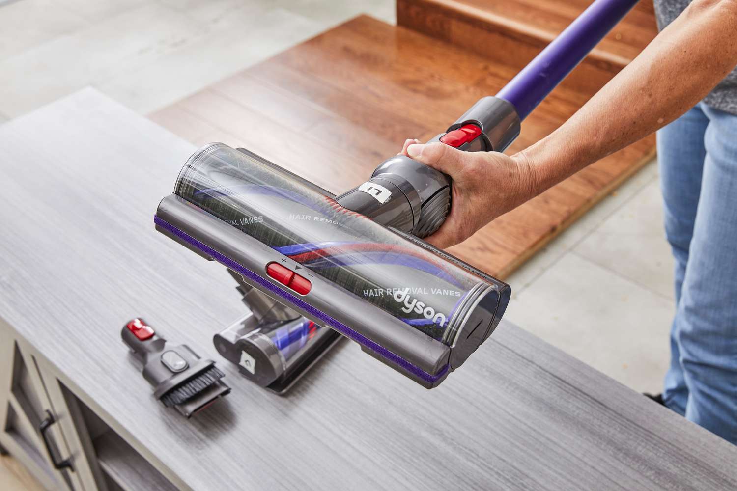 Person swapping attachments for the Dyson Gen5detect stick vacuum