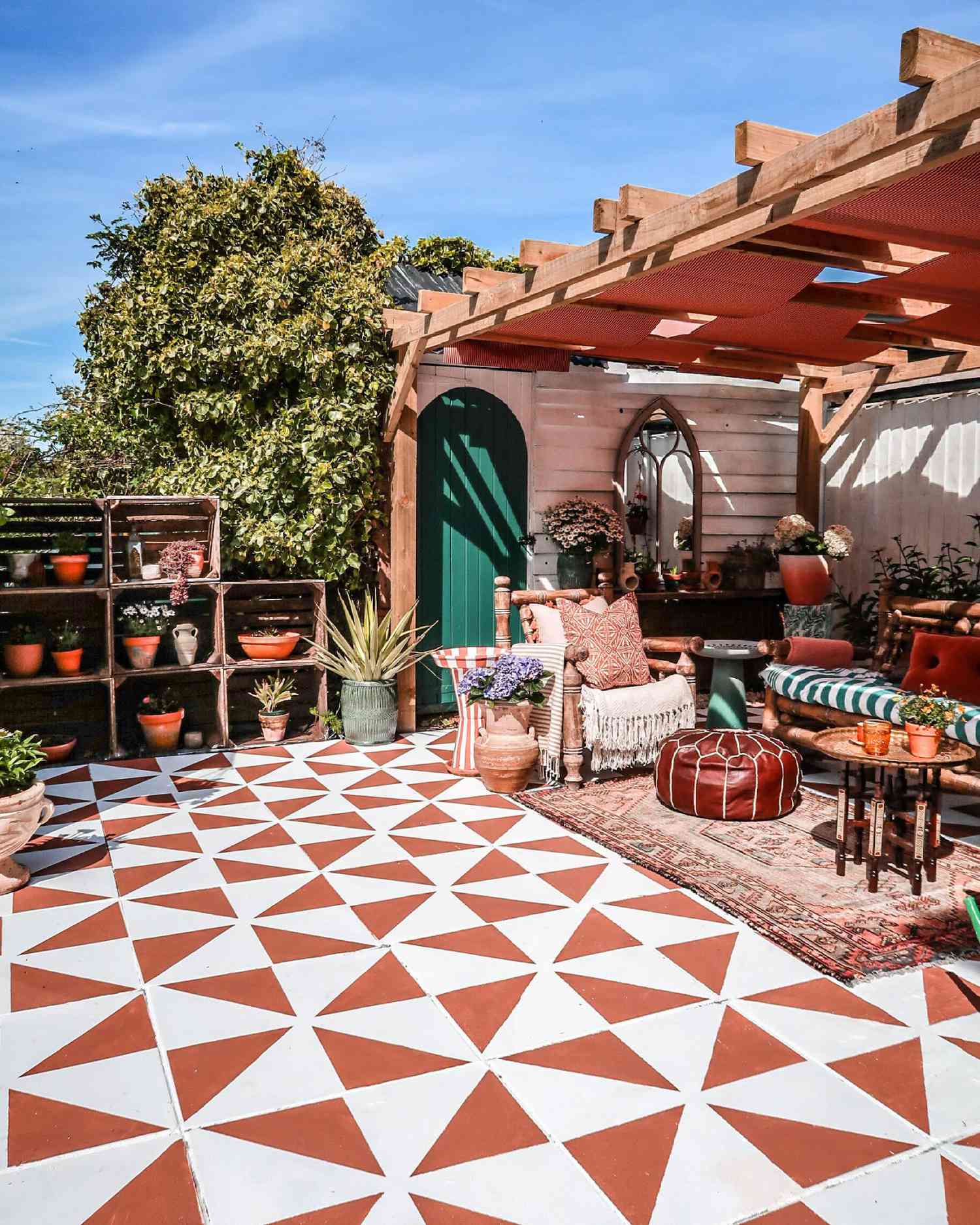 patterned patio with potted plants and teal green door