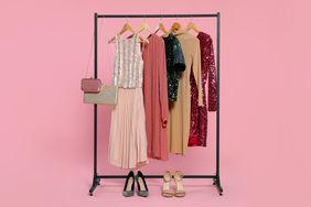 Clothing rack with outfits lined up and shoes