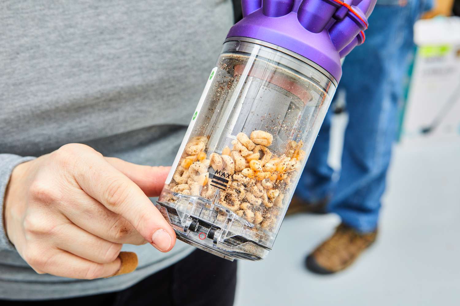 Person holding the disposal section of the Dyson Omni-Glide+ Cordless Vacuum