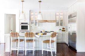 Remodeled white kitchen with island and blacksplash