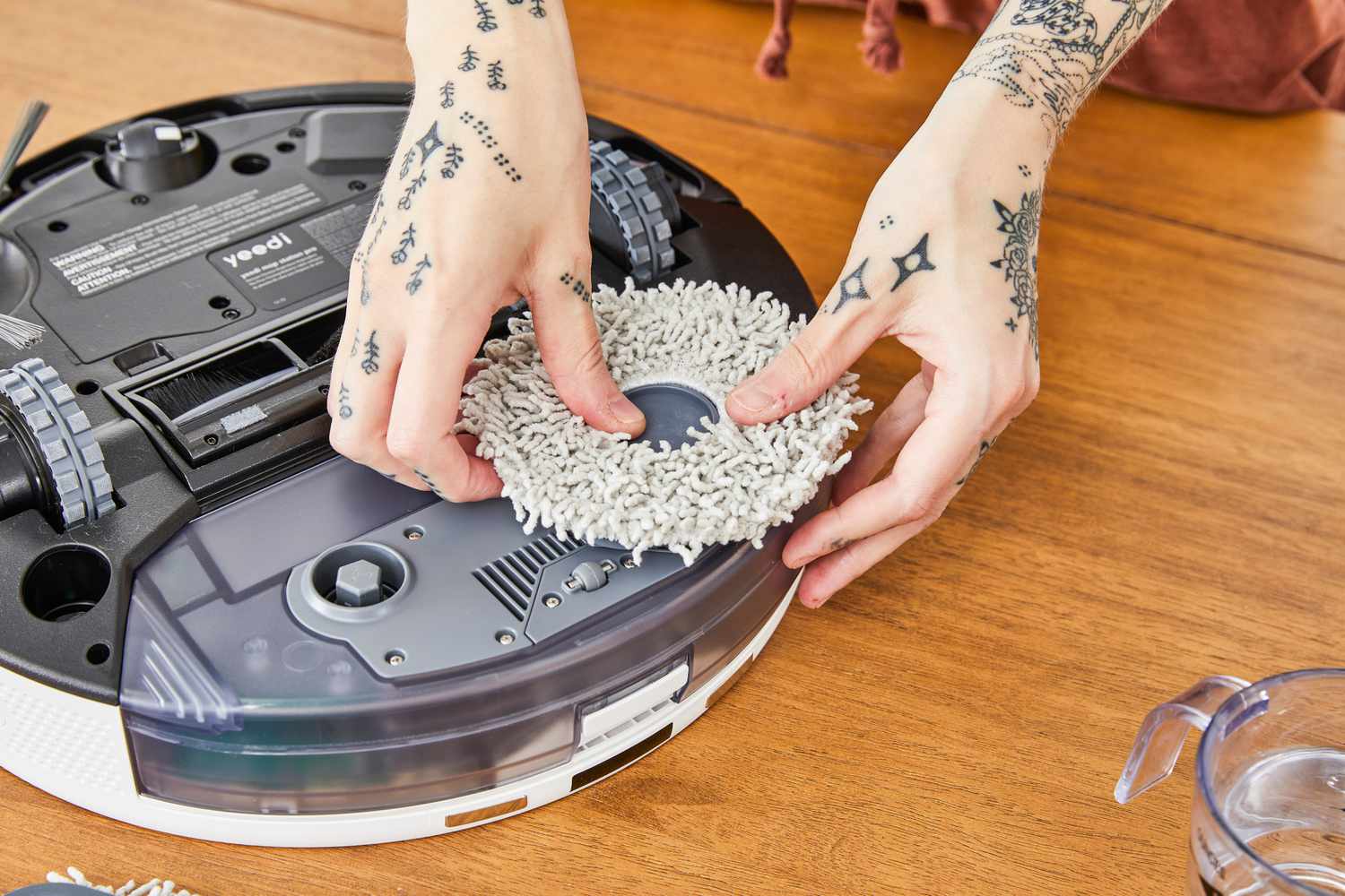 A person installs a mop head onto the Yeedi mop Station pro Robot Vacuum and Mop