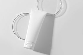 Close-Up Of Cosmetic Bottle Against White Background
