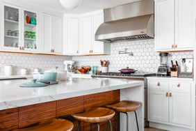 Kitchen with marble countertop and waterfall island