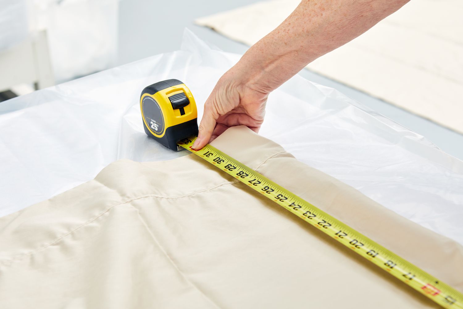 Person using measuring tape on Lands' End 400 Thread Count Premium Supima Cotton No Iron Sateen Bed Sheet Set 
