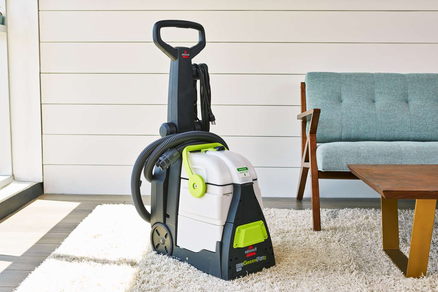 Bissell Big Green Pet Pro Carpet Cleaner displayed next to a couch and coffee table