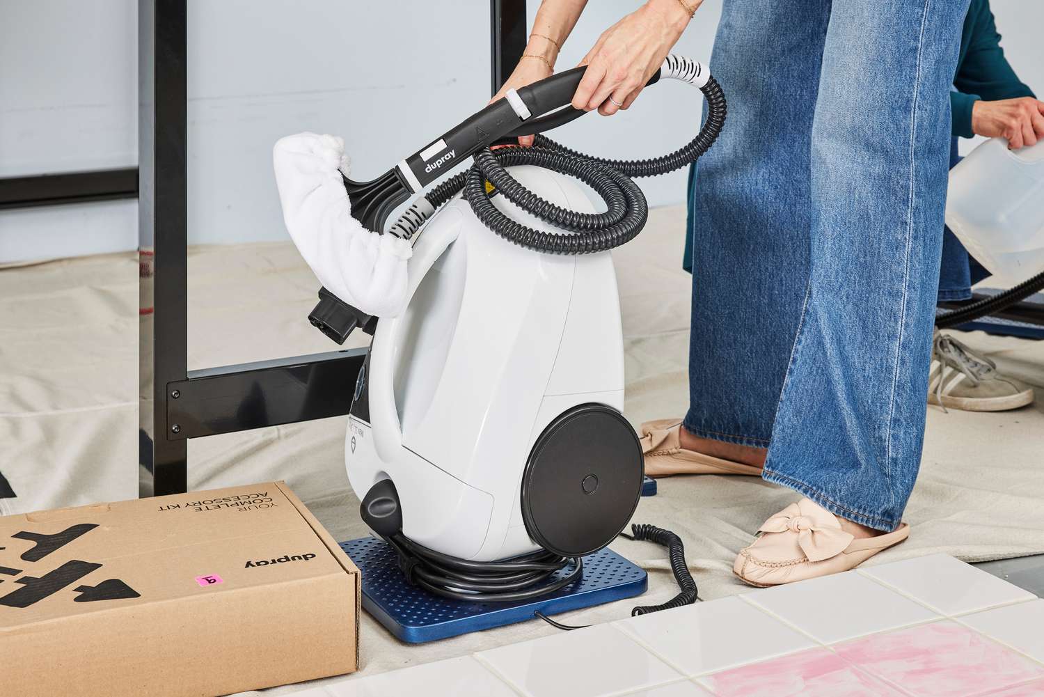 Person holds the hose on a Dupray One Steam Cleaner