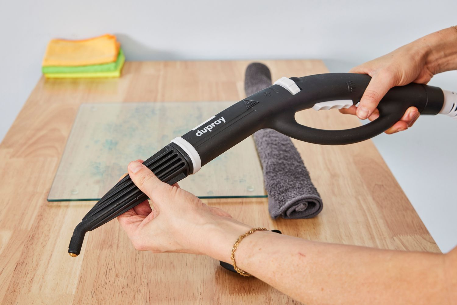 Hands hold the hose of a Dupray One Steam Cleaner