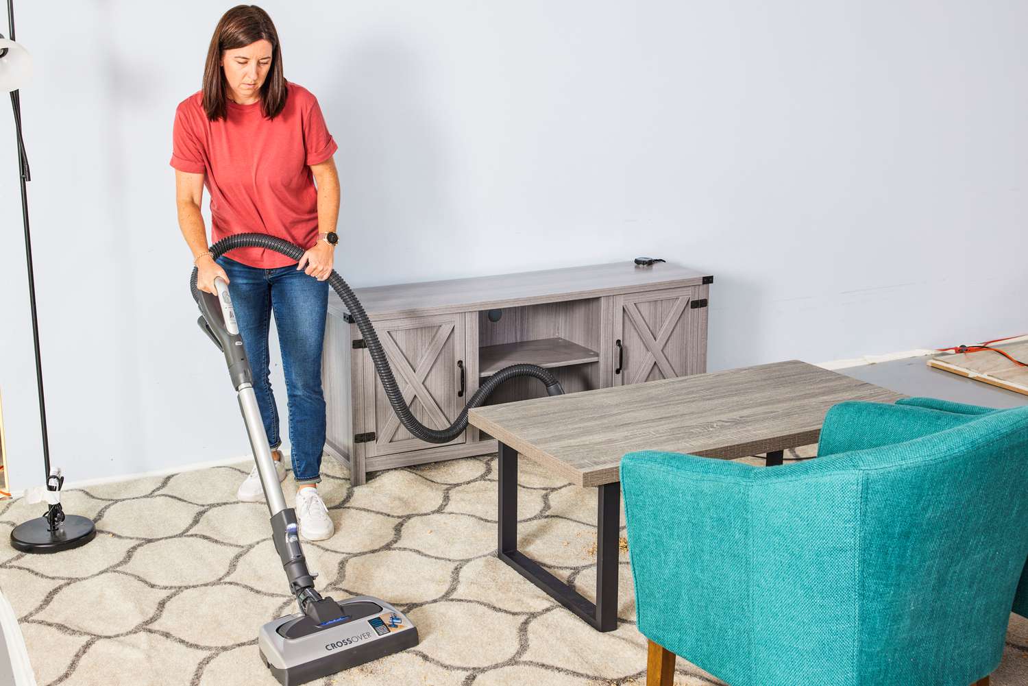 A person vacuums a rug using the Kenmore Elite CrossOver Bagged Canister Vacuum 21814