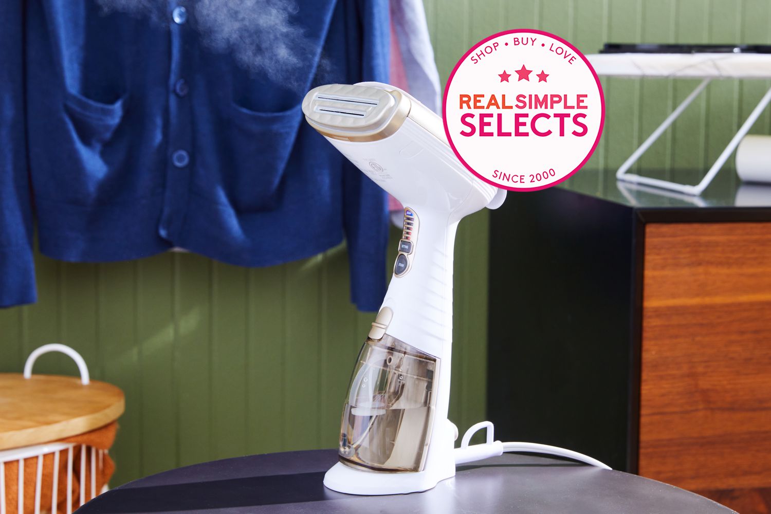 Conair Turbo ExtremeSteam Hand-Held Fabric Steamer displayed on a round table