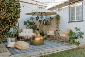 patio with rug and pouf, large umbrella and outdoor sofa