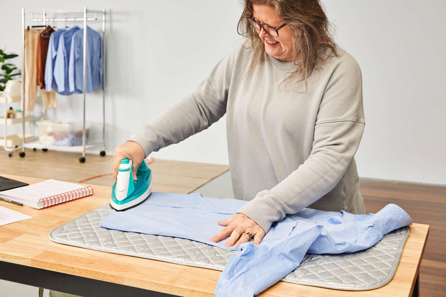 A person ironing a shirt on the BNYD Portable Ironing Mat Blanket