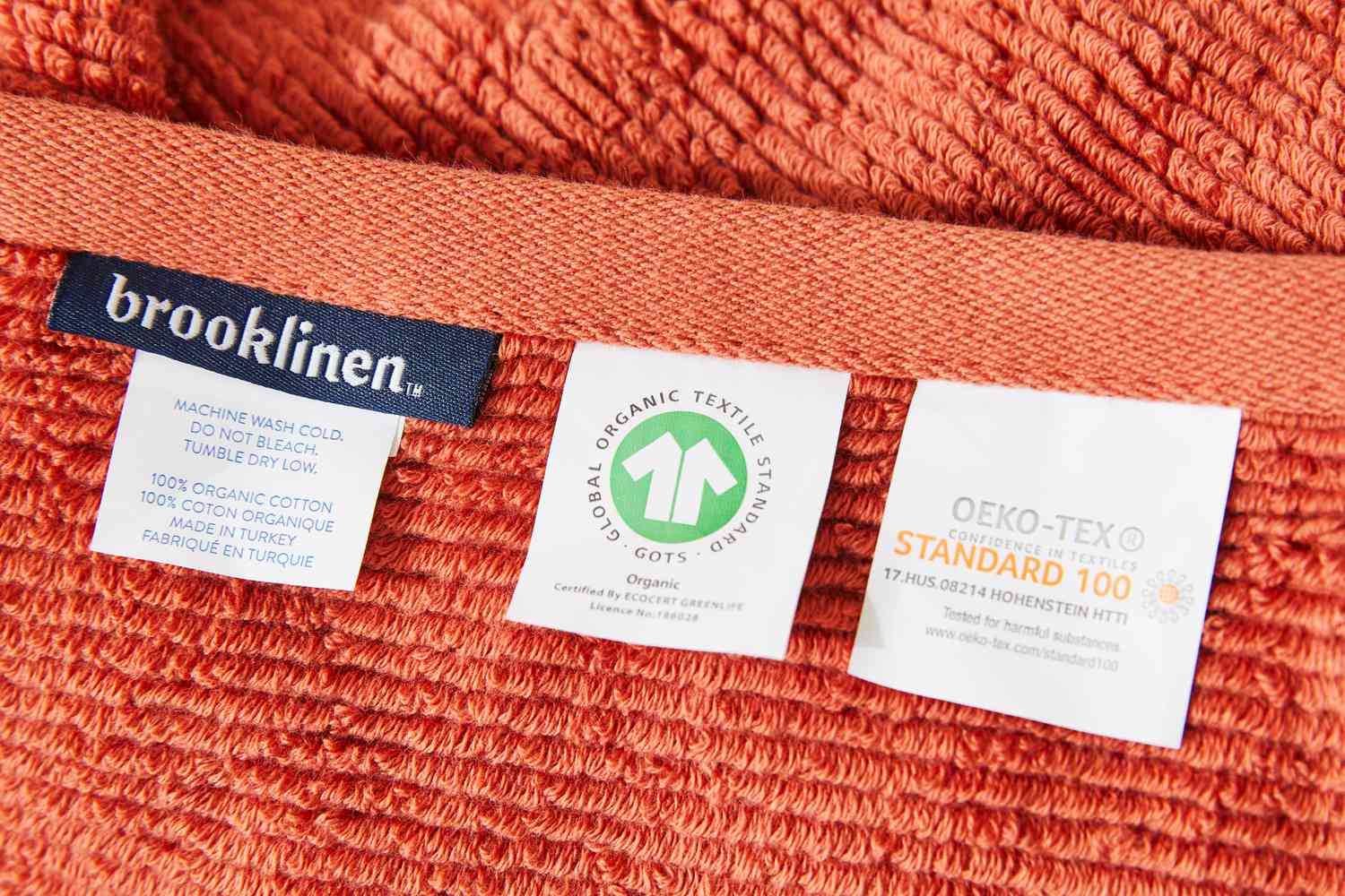 Closeup of care and certification tags on Brooklinen Organic Ribbed Bath Towel