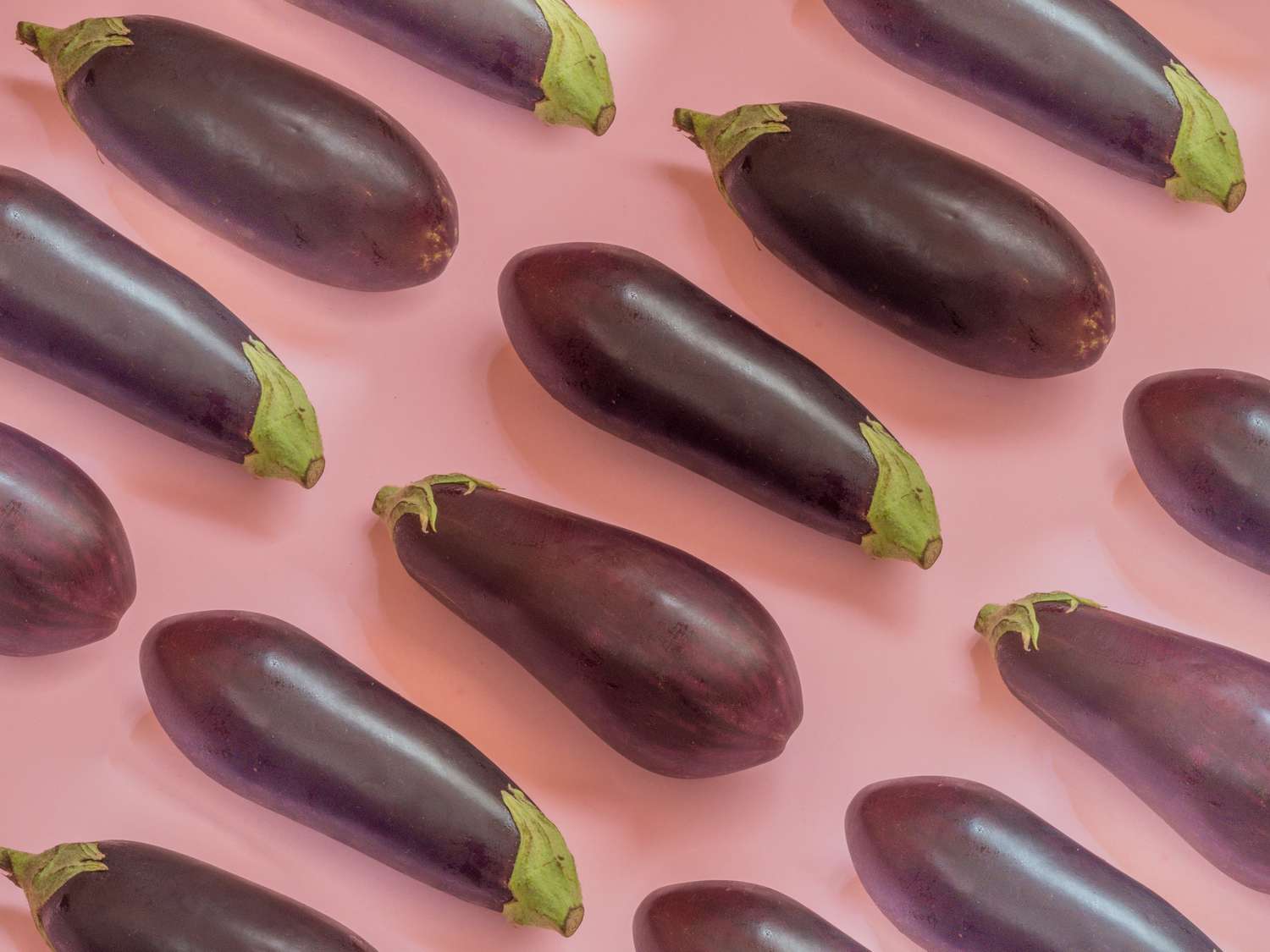 Eggplants on a pink background