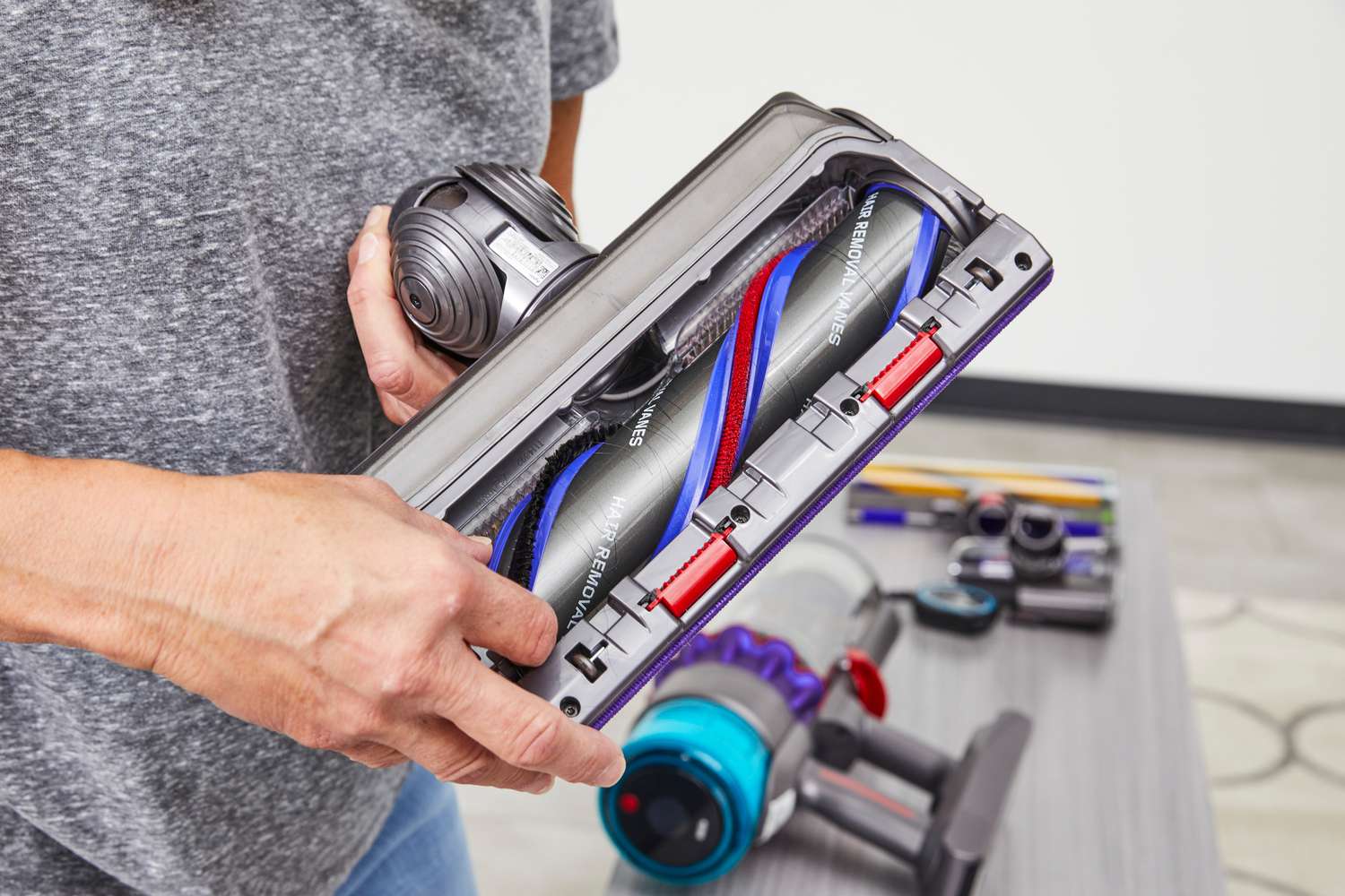 Person holding the carpet cleaning attachment of the Dyson Gen5detect stick vacuum