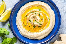 Hummus Nutrition and Health Benefits: hummus in a plate with pita bread.