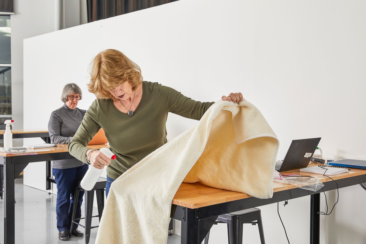 Woman spraying Italic Serene Ultraplush Australian Cotton Towels during testing