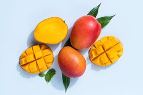 High Sugar Fruits: Mango cut open on a blue background