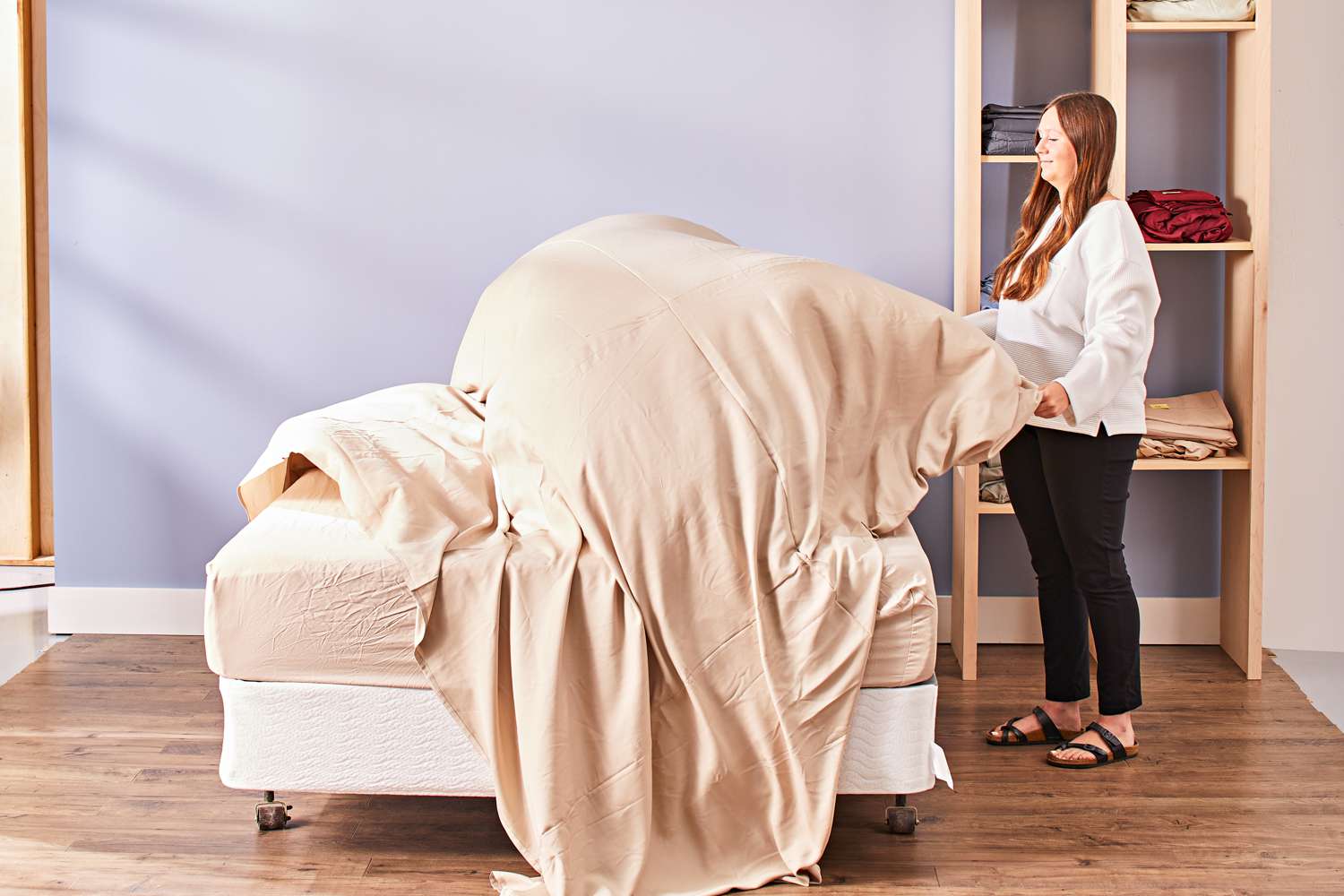 A person lifting up the Cozy Earth Bamboo Sheet Set