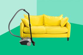 bright yellow sofa and vacuum cleaner on carpet isolated on white