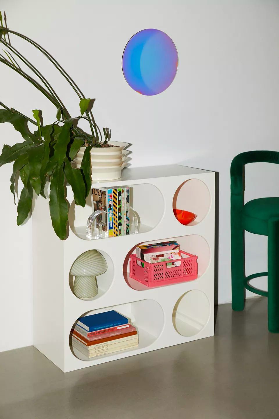 bookshelf with round and oval cutouts