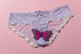 Women underwear with purple fake butterfly on pink background.Concept of intimacy.Studio shot