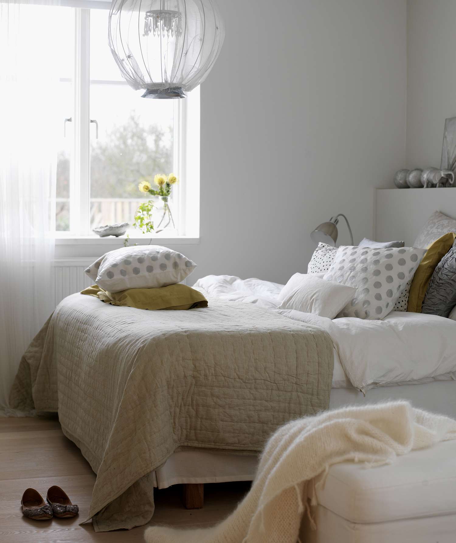 Light airy bedroom with pillows and throws