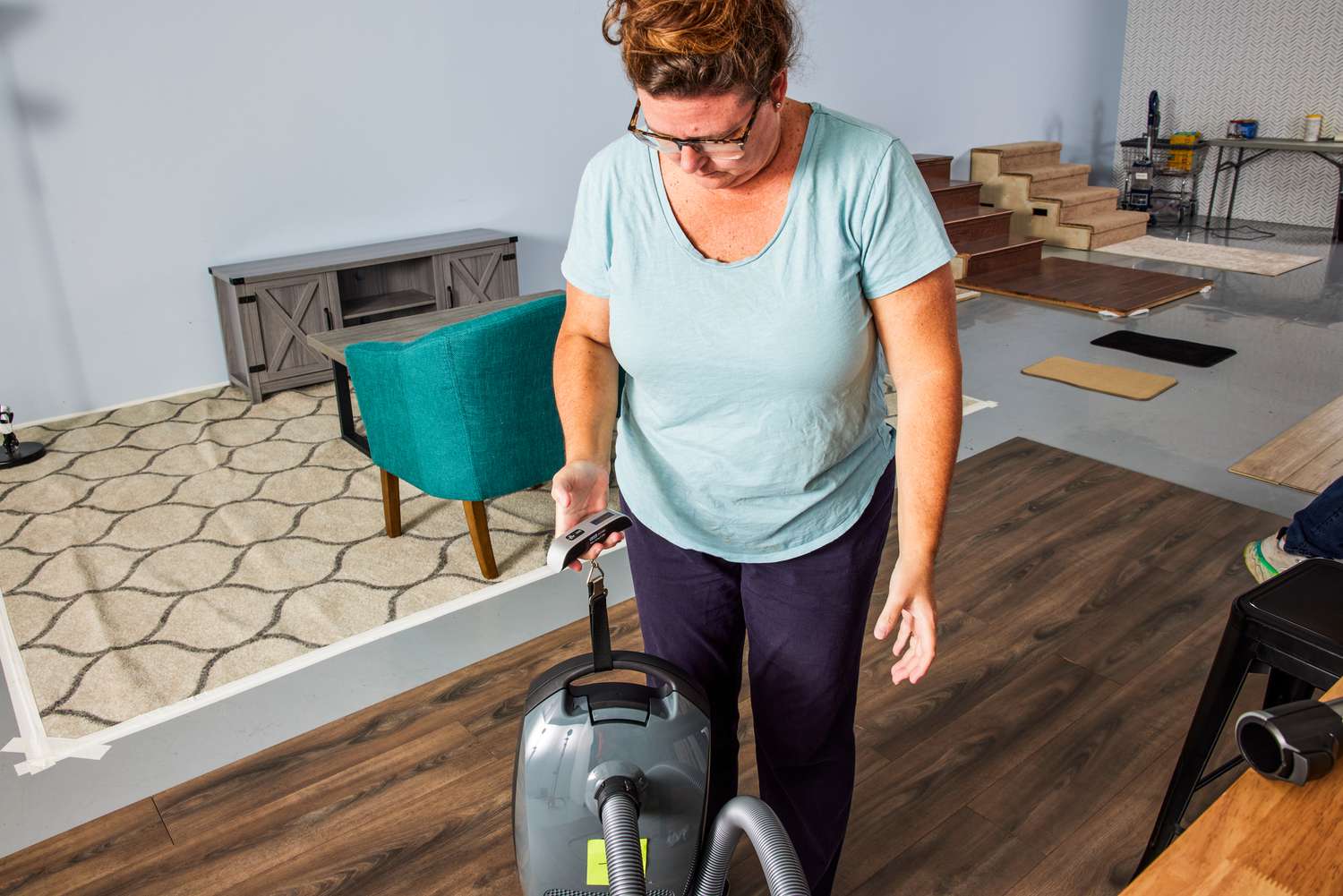 A person weighing the Miele Classic C1 Pure Suction PowerLine Vacuum.
