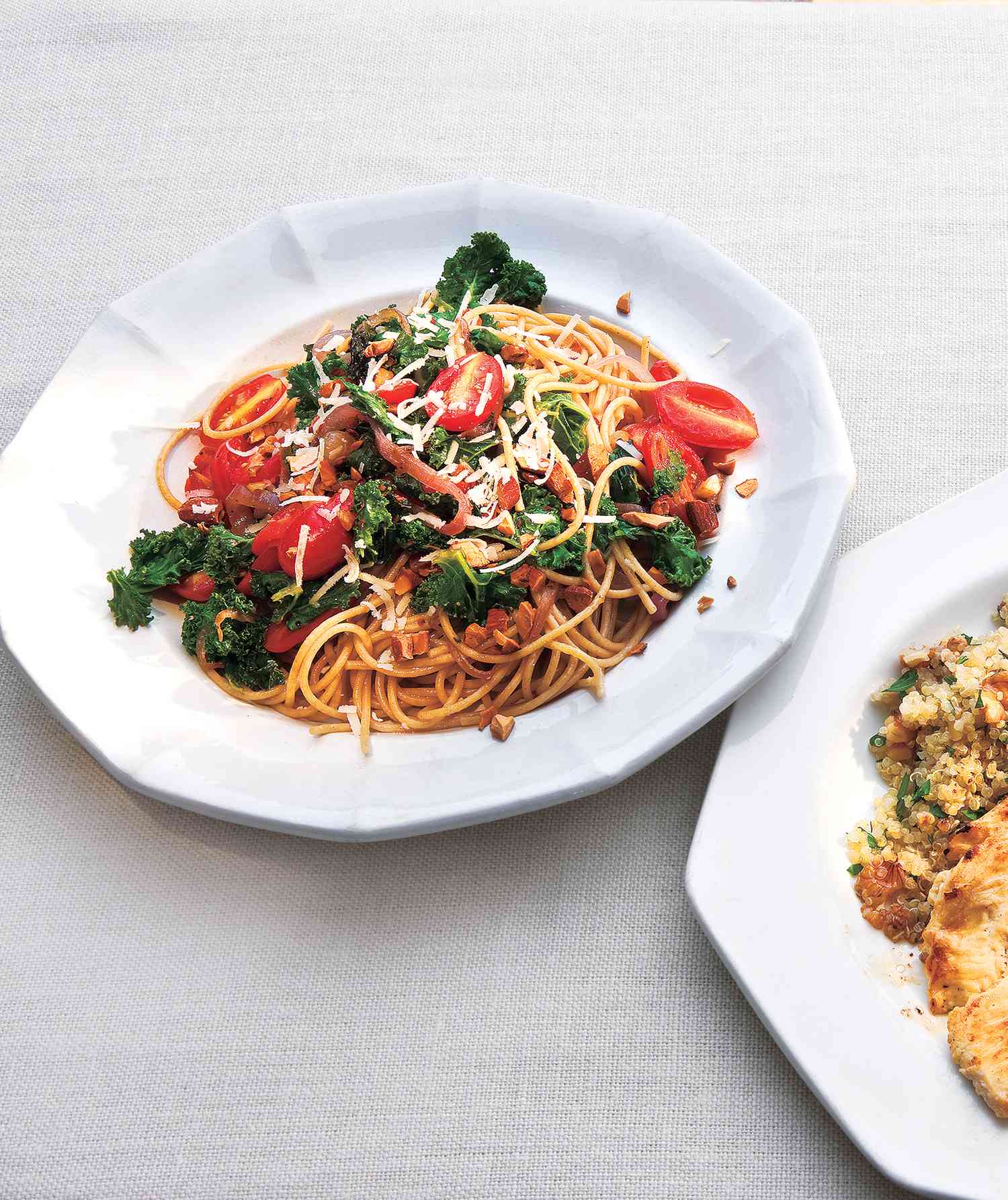 Whole Grain Spaghetti With Kale and Tomatoes Served on a White Platter