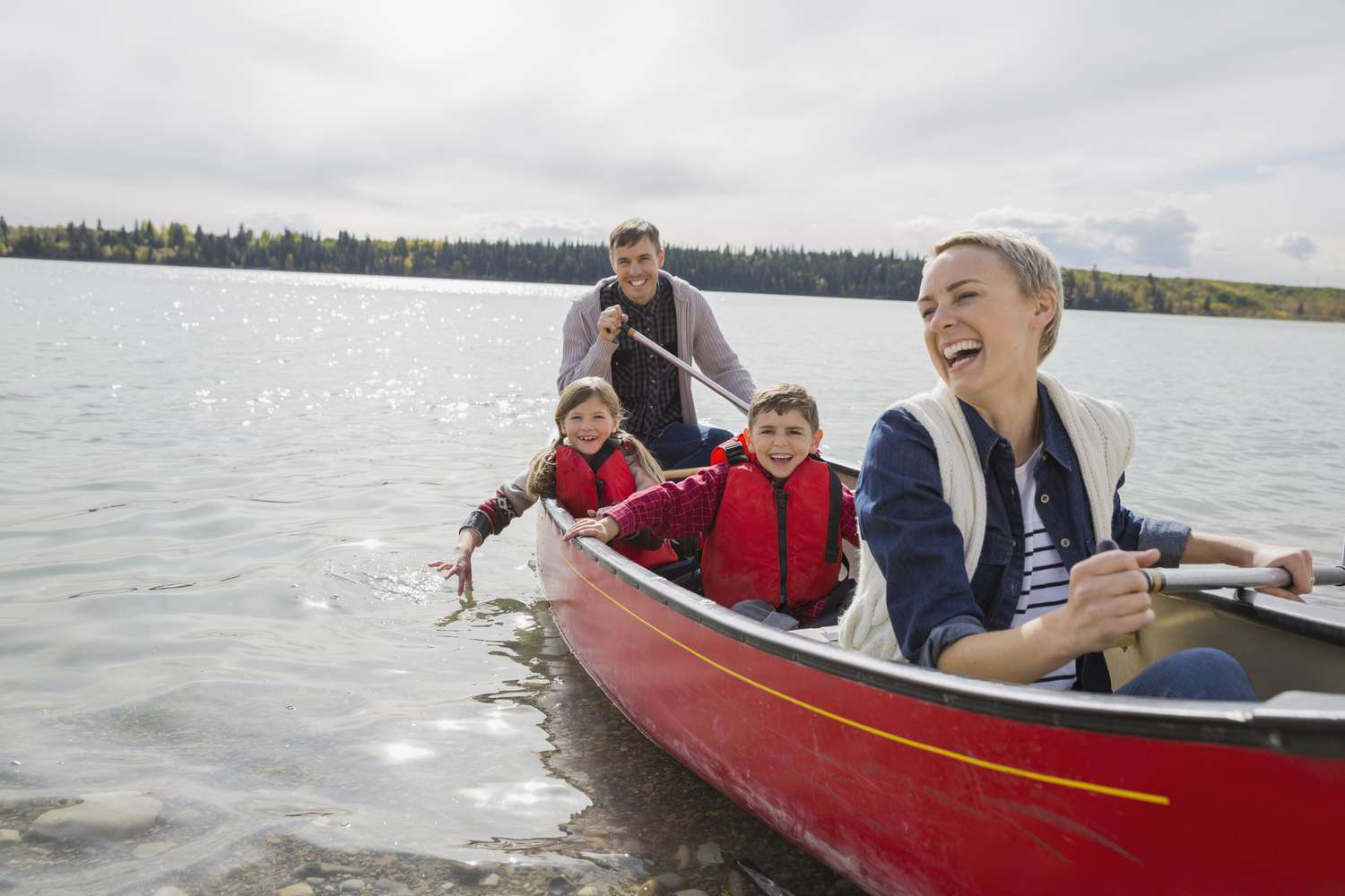 Happy family canoeing on lake