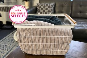laundry basket filled with clothes with a Real Simple tested badge