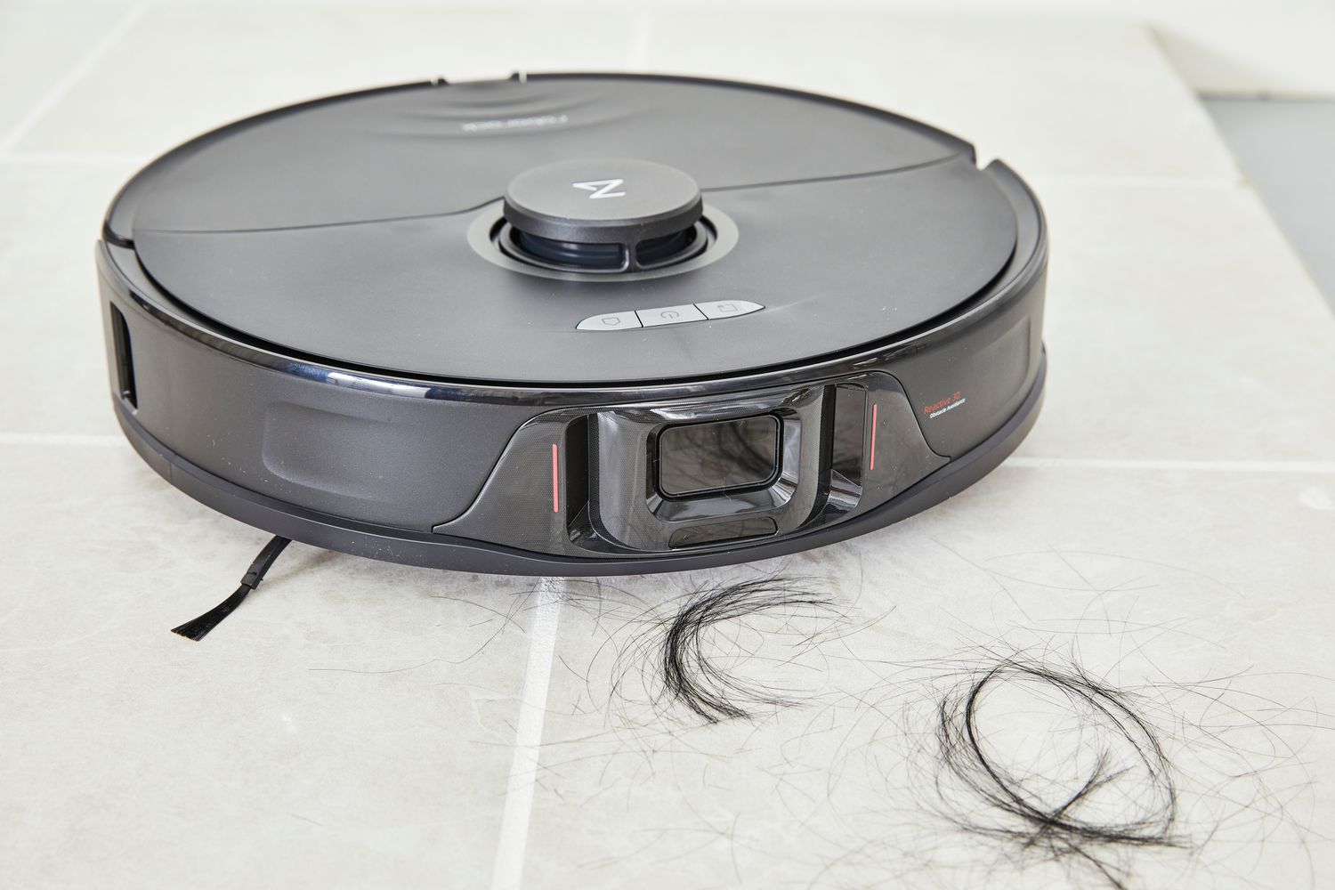 The Roborock S8 Plus cleans hair from a tile floor