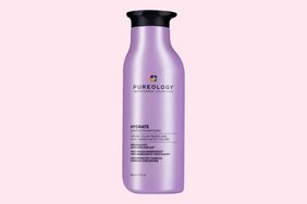 A bottle of Pureology Hydrate Shampoo on a pink background