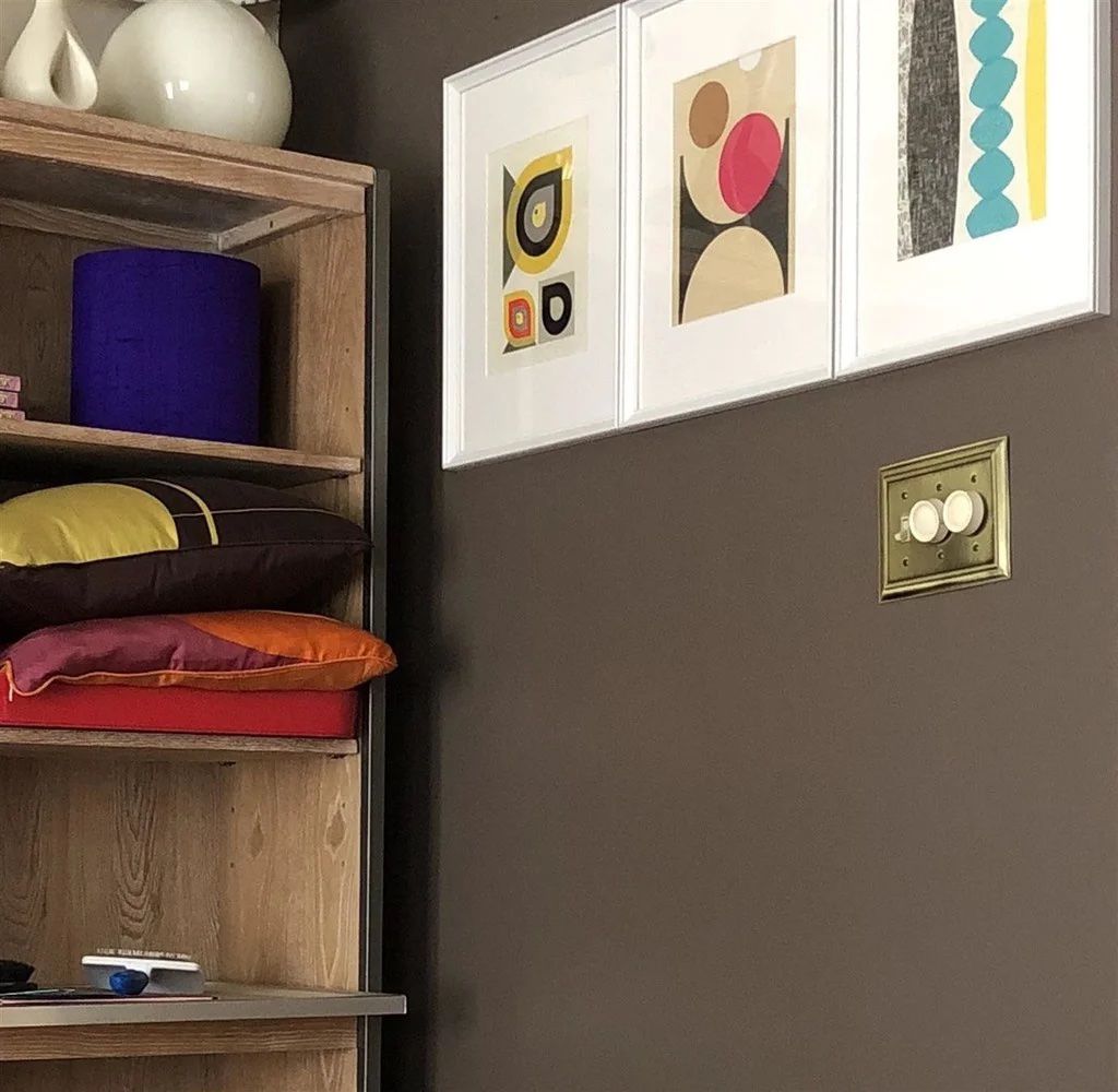 A wall painted in Farrow & Ball's London Clay, a warm, earthy brown.