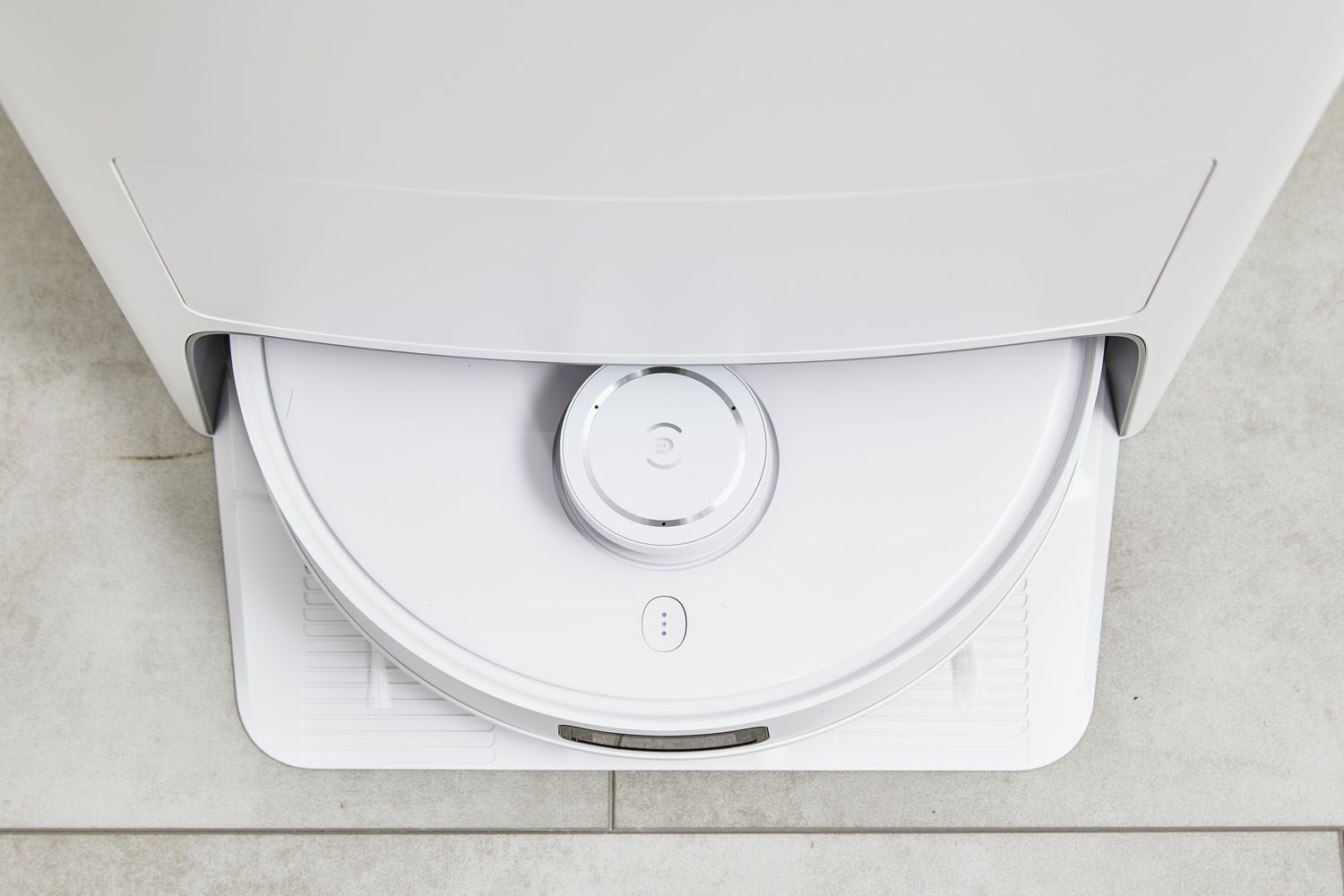 Ecovacs Deebot T10 Omni Robot Vacuum and Mop Combo sits in the charging station on tile 