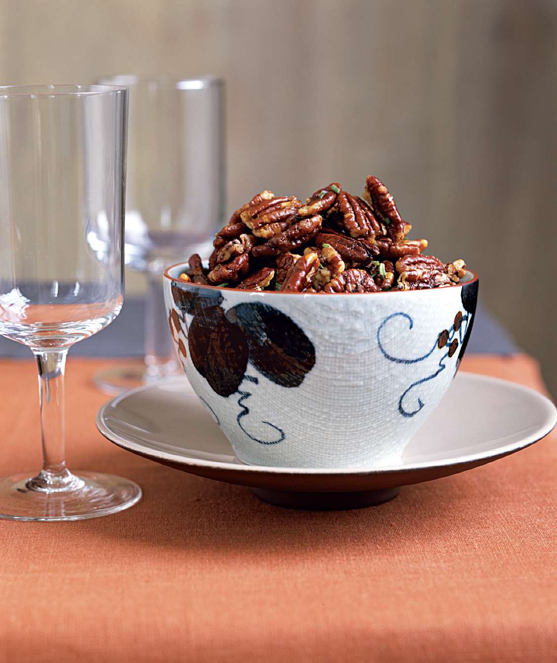 Rosemary pecans are served in a decorative bowl.
