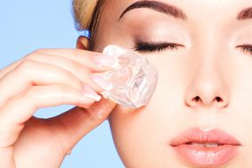 ice-facial: woman applying ice cube to skin