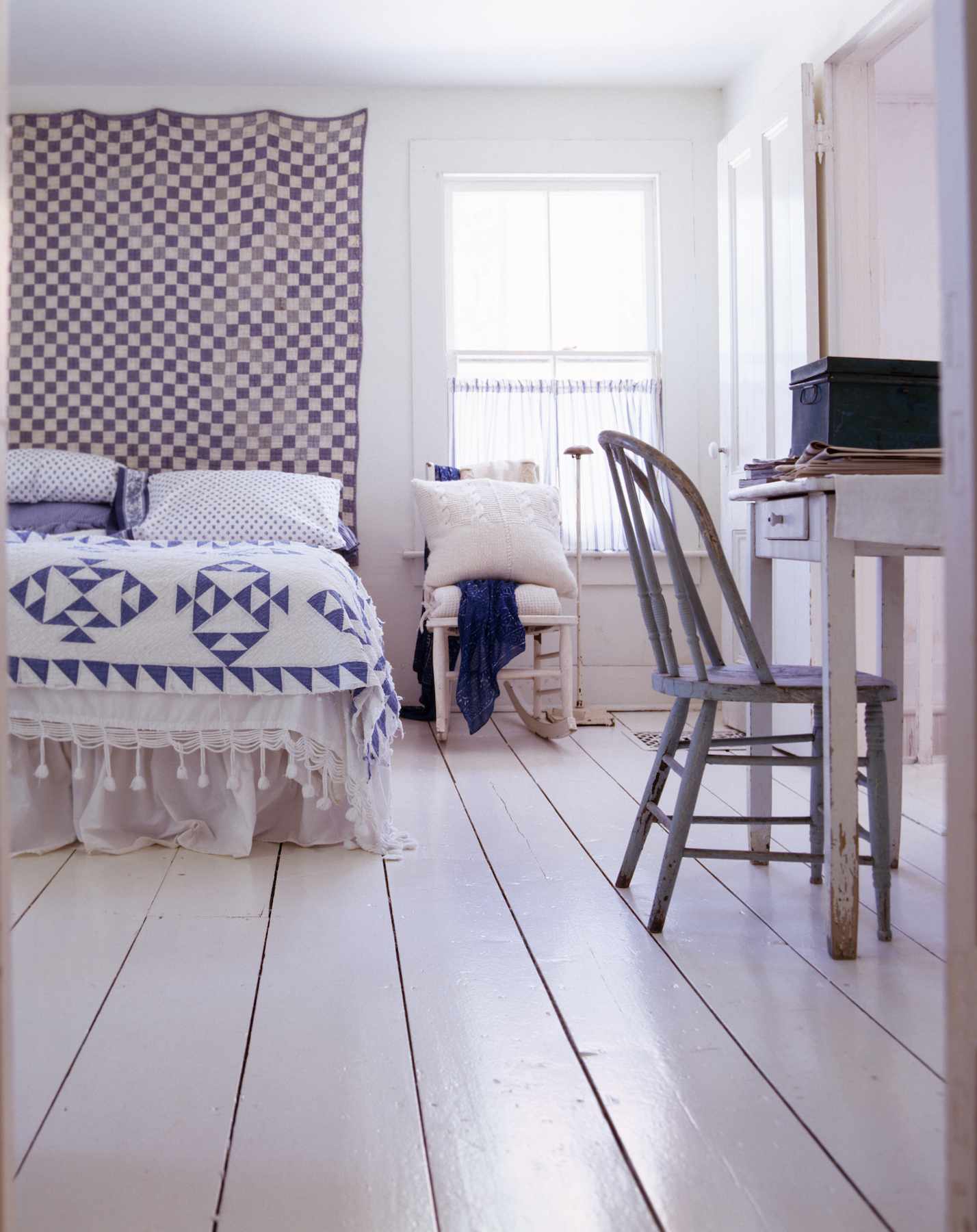 Pink bedroom with tapestry and chair