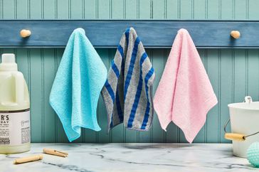 A variety of microfiber towels being hanged on towel hooks