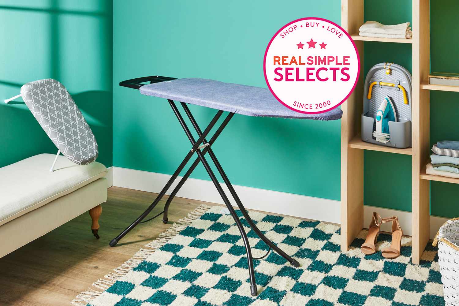A variety of ironing boards in a green painted room with a checkered print rug