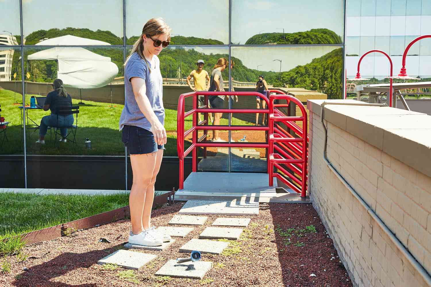 Person dropping a INNAV8 Water Hose Nozzle Sprayer nozzle cement stepping stone during testing 